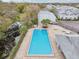Community pool area features pool furniture and community building at 7224 E Bank Dr # 206, Tampa, FL 33617