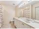 Bathroom featuring double sinks and a large mirror over the white vanity at 7224 E Bank Dr # 206, Tampa, FL 33617