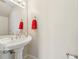Bathroom vanity with a white sink, a bright light fixture, and a red towel at 7224 E Bank Dr # 206, Tampa, FL 33617