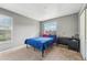 Bedroom with a bed covered in a blue quilt, a window, and a desk at 7224 E Bank Dr # 206, Tampa, FL 33617