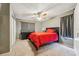 Bedroom with a red bedspread, a ceiling fan, and gray curtains at 7224 E Bank Dr # 206, Tampa, FL 33617