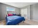 Bedroom featuring a bright window, a bed covered in a blue quilt, and double closet doors at 7224 E Bank Dr # 206, Tampa, FL 33617