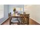 Cozy dining area featuring wood flooring and seamless transition to kitchen through serving hatch at 7224 E Bank Dr # 206, Tampa, FL 33617