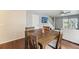 Dining room with wood floors, a wood table and a view into the living area and staircase at 7224 E Bank Dr # 206, Tampa, FL 33617