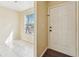 Bright foyer with tile flooring and front door leading to additional space with natural light and a window at 7224 E Bank Dr # 206, Tampa, FL 33617