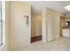 Hallway with ample closet space, ceramic tile floors, and a view into the kitchen at 7224 E Bank Dr # 206, Tampa, FL 33617