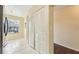 Hallway with white-painted closet doors and a view of a window with natural light at 7224 E Bank Dr # 206, Tampa, FL 33617
