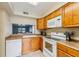Functional kitchen featuring sleek appliances, abundant cabinet space, and a convenient pass-through window at 7224 E Bank Dr # 206, Tampa, FL 33617