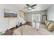 Well-lit living room showcases wood flooring, a ceiling fan and large television for an entertainment experience at 7224 E Bank Dr # 206, Tampa, FL 33617