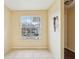 Bright living room with tile floors and a large window overlooking the parking area at 7224 E Bank Dr # 206, Tampa, FL 33617