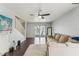 Spacious living room with dark wood floors, neutral walls, sliding glass doors and a staircase at 7224 E Bank Dr # 206, Tampa, FL 33617