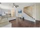 Living room with dark wood floors, a ceiling fan and sliding glass doors to a private patio at 7224 E Bank Dr # 206, Tampa, FL 33617