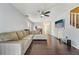 Spacious living room featuring dark wood floors, a ceiling fan and seamless flow to dining area at 7224 E Bank Dr # 206, Tampa, FL 33617