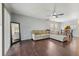 Bright living room with dark wood floors, open to dining area, and a cozy sectional sofa at 7224 E Bank Dr # 206, Tampa, FL 33617