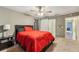 Spacious bedroom with carpet, ceiling fan, and an ensuite bathroom with barn door access at 7224 E Bank Dr # 206, Tampa, FL 33617