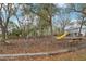 Playground with mature shade trees, benches, a swing set, slide, and a geodesic dome climber at 7224 E Bank Dr # 206, Tampa, FL 33617