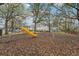Community playground with mature shade trees, swing set, and slide at 7224 E Bank Dr # 206, Tampa, FL 33617
