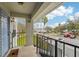 View from porch featuring a staircase, metal railing and a parking lot with mature trees at 7224 E Bank Dr # 206, Tampa, FL 33617