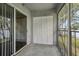 Screened porch with concrete floor, and white storage closet, and sliding glass door at 7224 E Bank Dr # 206, Tampa, FL 33617