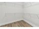 Walk-in closet features wire shelving and wood-look flooring at 7254 Kodiak Ln, Sarasota, FL 34240