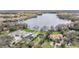 Stunning aerial view of luxurious waterfront homes with private pools, lush landscaping, and lake access at 7730 N Mobley Rd, Odessa, FL 33556