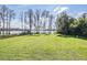 This backyard has lush green grass and offers scenic lake views at 7730 N Mobley Rd, Odessa, FL 33556