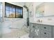 Stunning bathroom featuring a glass shower with a rain shower head and a marble vanity with mirrored cabinet doors at 7730 N Mobley Rd, Odessa, FL 33556