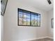 A bright room featuring a large window providing ample natural light, complemented by neutral walls and light-colored flooring at 7730 N Mobley Rd, Odessa, FL 33556