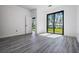 Bright bedroom with a sliding glass door with a view of the lake at 7730 N Mobley Rd, Odessa, FL 33556