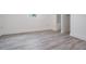A bright bedroom features hard surface floors and white trim and paint at 7730 N Mobley Rd, Odessa, FL 33556