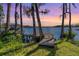 Waterfront property with a private dock featuring stunning sunset views at 7730 N Mobley Rd, Odessa, FL 33556
