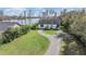 Charming home featuring fresh landscaping, a well-manicured lawn, and convenient driveway access at 7730 N Mobley Rd, Odessa, FL 33556
