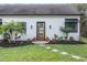 Charming home with a wooden front door, well-kept lawn, and tidy landscaping at 7730 N Mobley Rd, Odessa, FL 33556