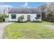 Exterior of the property featuring manicured front lawn and a well-maintained facade and driveway at 7730 N Mobley Rd, Odessa, FL 33556