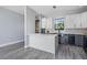 Well-lit kitchen featuring a large island, stainless steel appliances, and two-tone cabinets at 7730 N Mobley Rd, Odessa, FL 33556