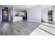 Open-concept living space with wood-look floors leading to the kitchen at 7730 N Mobley Rd, Odessa, FL 33556
