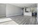 Spacious living room adjacent to a modern kitchen with sleek flooring and ample natural light at 7730 N Mobley Rd, Odessa, FL 33556