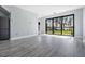 Living space featuring a view of the lake and a sliding glass door, plus modern grey refrigerator at 7730 N Mobley Rd, Odessa, FL 33556