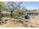 Grassy backyard featuring a screened-in pool, a privacy fence and mature trees creating a relaxing outdoor space at 8248 Goodrich St, Spring Hill, FL 34606