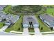 Aerial view of homes featuring manicured lawns, symmetrical driveways, and beautiful community landscaping at 8435 Ocean Tides Cv, Parrish, FL 34219