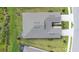 A high-angle, aerial view shows symmetrical driveways, green lawns and landscaped gardens of multiple homes at 8435 Ocean Tides Cv, Parrish, FL 34219