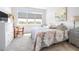 Bright bedroom with a flower-patterned bedspread, a wooden desk, and natural light at 8435 Ocean Tides Cv, Parrish, FL 34219