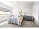 Cozy bedroom with a floral bedspread, large window, and neutral decor at 8435 Ocean Tides Cv, Parrish, FL 34219