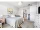 Well-lit bedroom featuring soft decor, a decorative chandelier, and an open doorway to a closet and bathroom at 8435 Ocean Tides Cv, Parrish, FL 34219