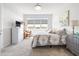 Bedroom with a comfortable bed, a dresser, and a window offering natural light at 8435 Ocean Tides Cv, Parrish, FL 34219