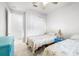 Spare bedroom with two twin beds, carpet flooring, closet with sliding doors and a window providing natural light at 8435 Ocean Tides Cv, Parrish, FL 34219