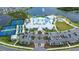 Aerial view of community clubhouse, pool, tennis courts, parking, and landscaping at 8435 Ocean Tides Cv, Parrish, FL 34219