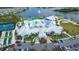 Overhead view of community clubhouse, pool, parking, and landscaped entrance at 8435 Ocean Tides Cv, Parrish, FL 34219