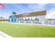 Welcoming Del Webb BayView community entrance with water feature and landscaping at 8435 Ocean Tides Cv, Parrish, FL 34219