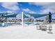 Stunning community pool area with ample seating, shade, and palm trees at 8435 Ocean Tides Cv, Parrish, FL 34219